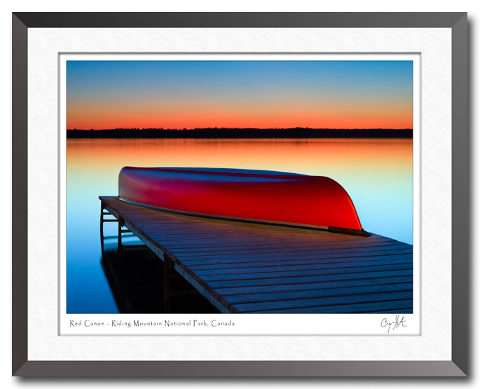 Red canoe resting on a dock